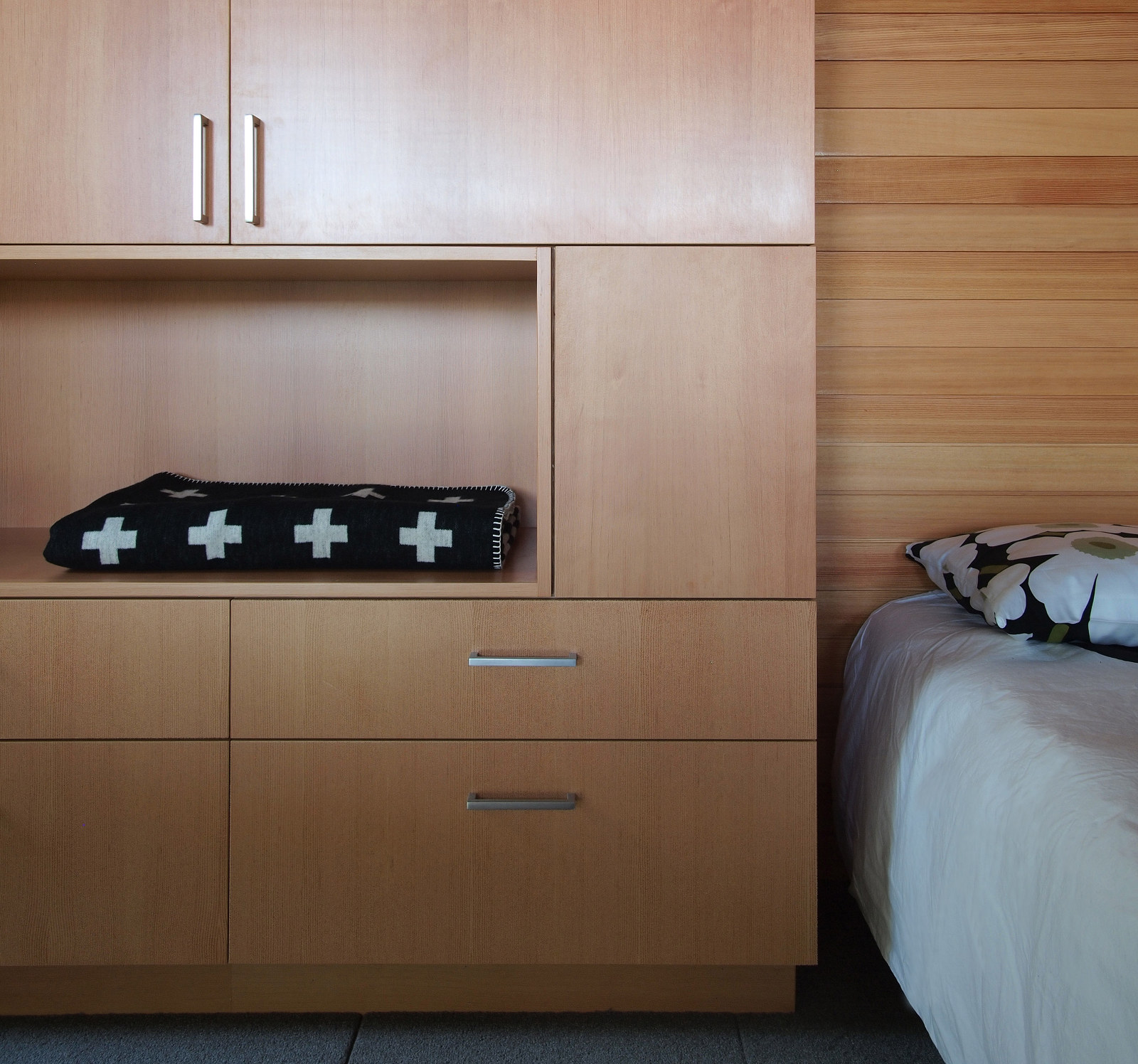 Custom cabinetry in bedroom with recessed niche open shelf.