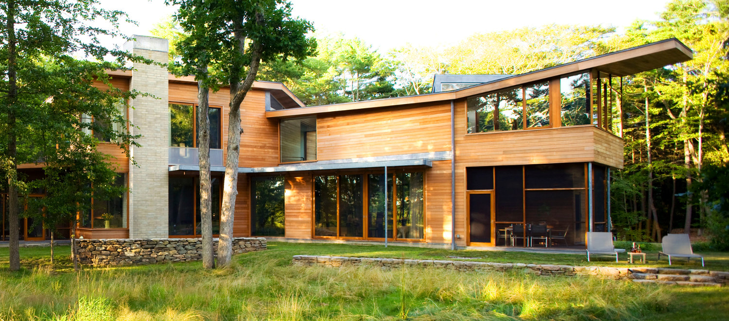 Exterior of modern house in Westport, MA, with horizontal wood (western red cedar) siding and wood-framed windows.